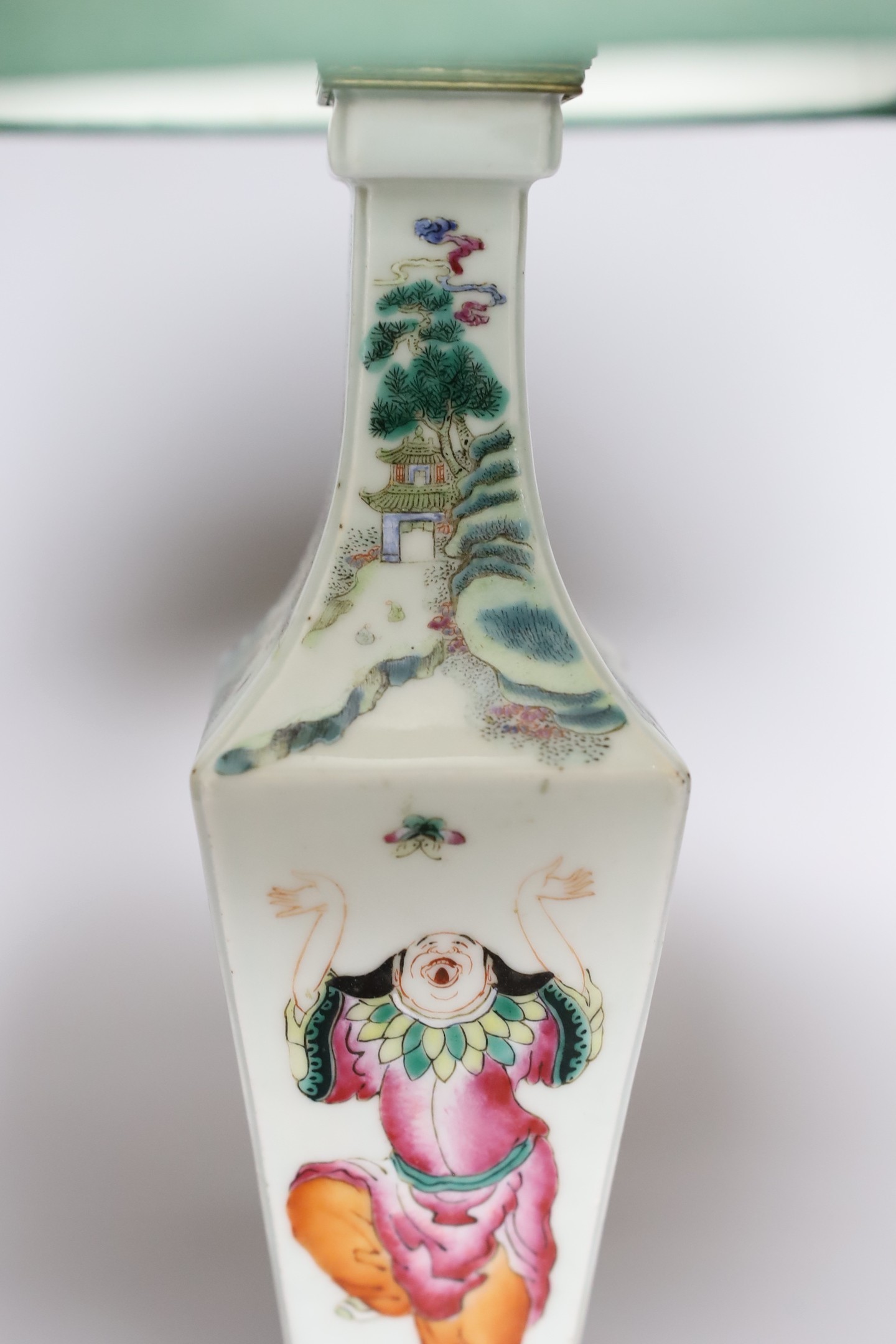 A Chinese famille rose ‘Liu Hai’ vase, late 19th century, with gilt mounts, drilled and converted to a lamp, 28 cms high